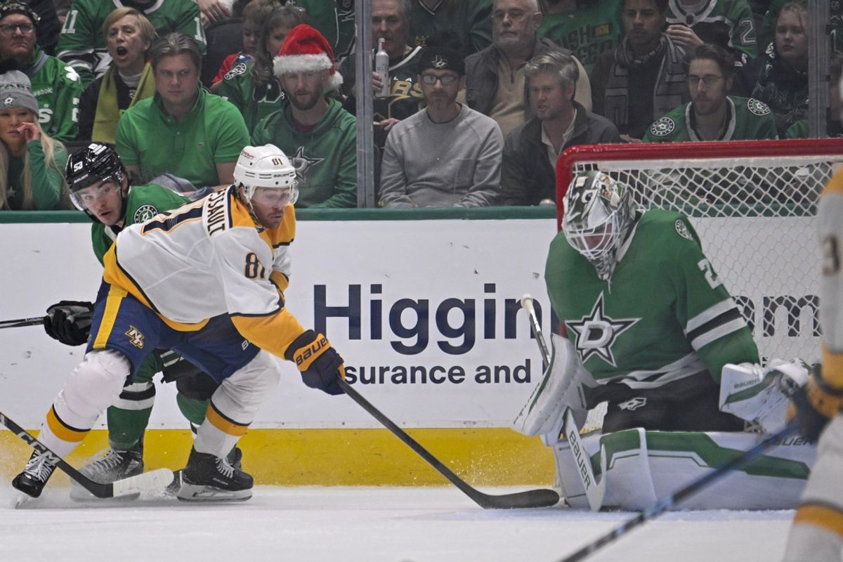 Dec 12, 2024; Dallas, Texas, USA;  Nashville Predators right wing Jonathan Marchessault (81) attempts to poke the puck past Dallas Stars goaltender Jake Oettinger (29) during the second period at the American Airlines Center. Mandatory Credit: Jerome Miron-Imagn Images