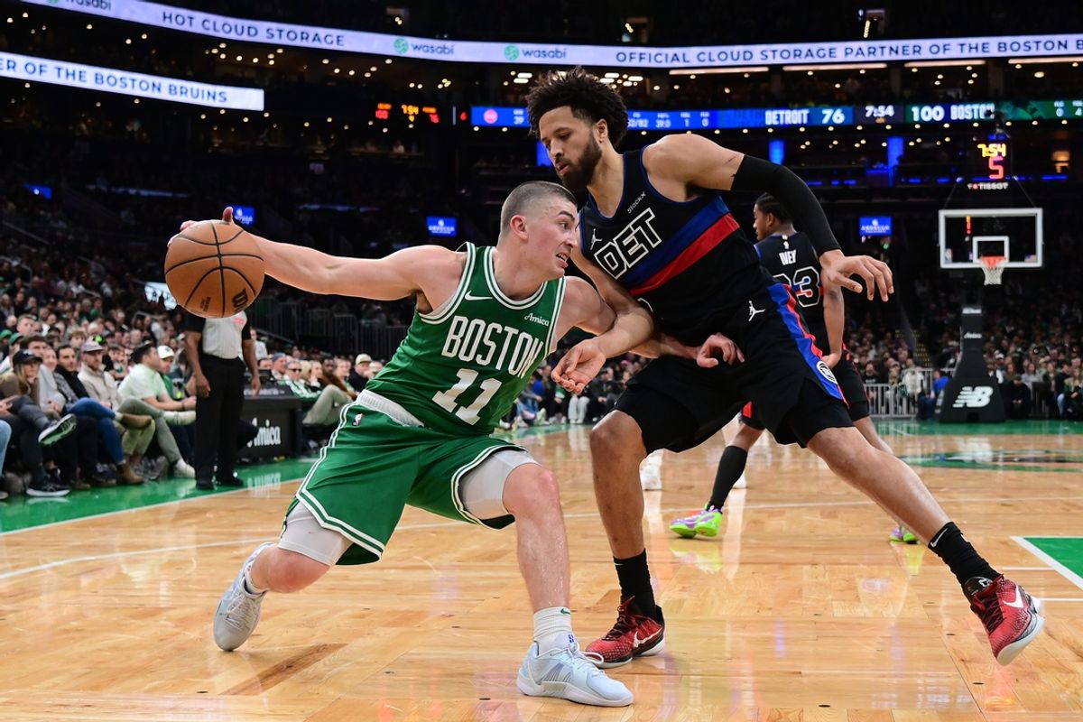 Dec 12, 2024; Boston, Massachusetts, USA;  Boston Celtics guard Payton Pritchard (11) drives to the basket against Detroit Pistons guard Cade Cunningham (2) during the second half at TD Garden. Mandatory Credit: Eric Canha-Imagn Images