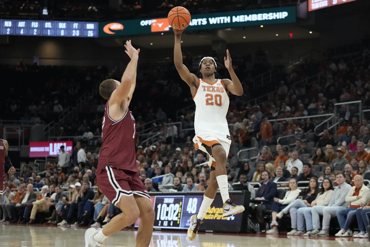 Dec 12, 2024; Austin, Texas, USA; Texas Longhorns guard Tre Johnson (20) passes the ball for an alley-oop over New Mexico State Aggies forward Peter Filipovity (12) during the second half at Moody Center. Mandatory Credit: Scott Wachter-Imagn Images