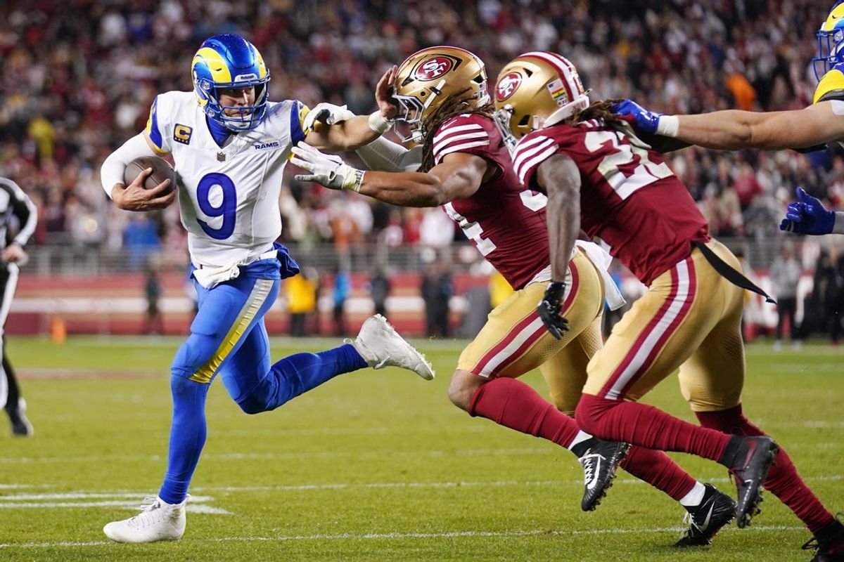 Dec 12, 2024; Santa Clara, California, USA; Los Angeles Rams quarterback Matthew Stafford (9) runs with the ball as San Francisco 49ers linebacker Fred Warner (54) defends in the fourth quarter at Levi's Stadium. Mandatory Credit: Cary Edmondson-Imagn Images