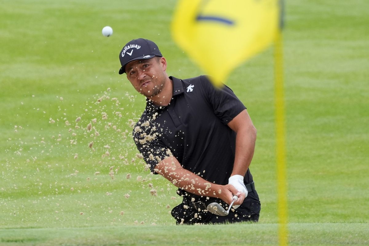 Xander Schauffele htis out of the bunker onto the green of the seventh hole during the second day of the PGA Championship at Valhalla Golf Club on Friday, May 17, 2024.