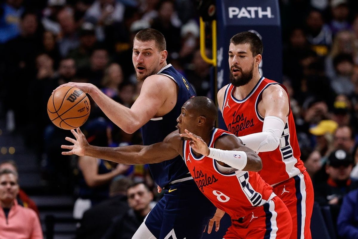 Dec 13, 2024; Denver, Colorado, USA; Los Angeles Clippers guard Kris Dunn (8) attempts to steal the ball away from Denver Nuggets center Nikola Jokic (15) as center Ivica Zubac (40) defends in the second quarter at Ball Arena. Mandatory Credit: Isaiah J. Downing-Imagn Images