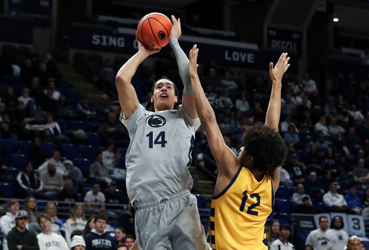 Dec 14, 2024; University Park, Pennsylvania, USA; Penn State Nittany Lions forward Yanic Konan Niederhauser (14) shoots the ball against Coppin State Eagles forward Peter Oduro (12) during the first half at Bryce Jordan Center. Mandatory Credit: Matthew O'Haren-Imagn Images