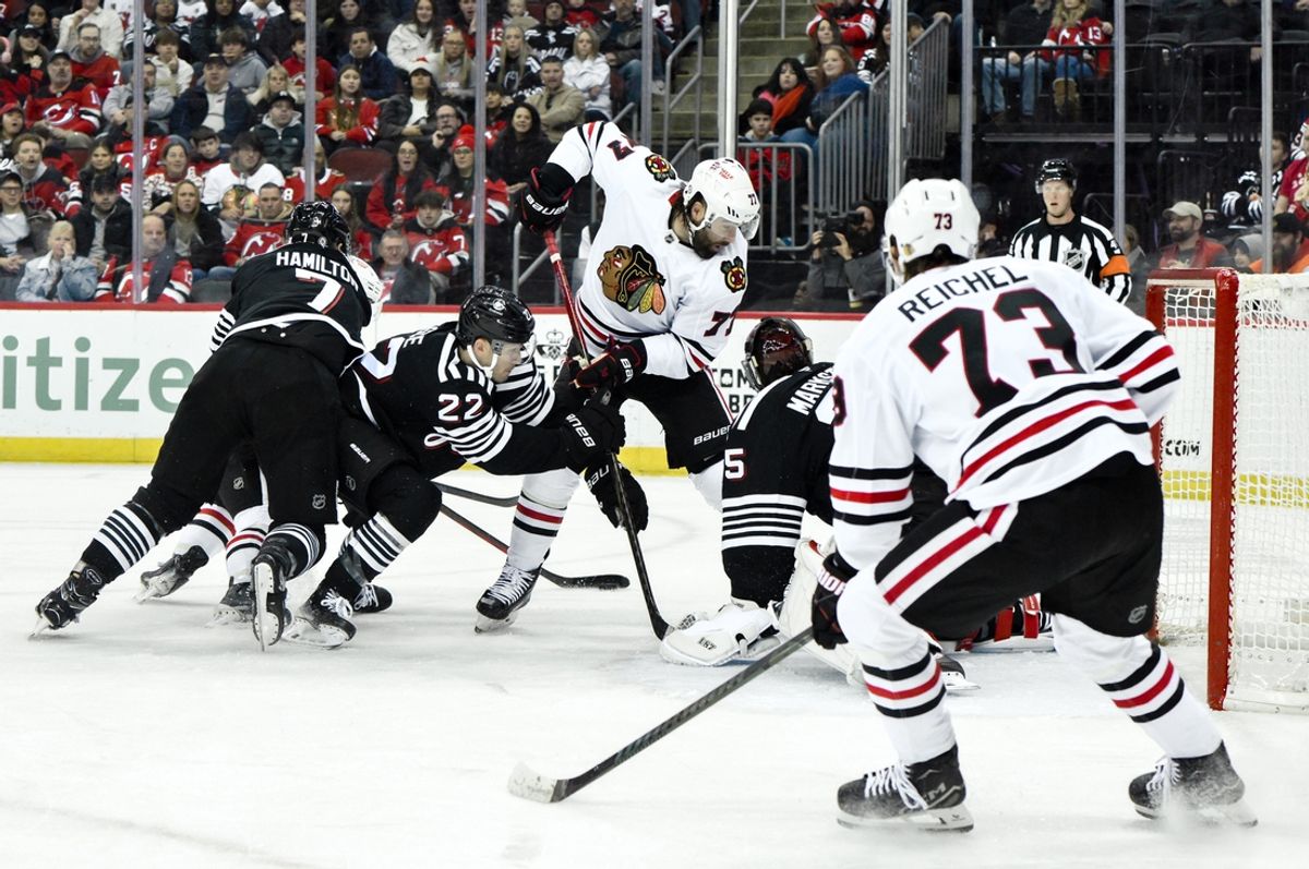 Dec 14, 2024; Newark, New Jersey, USA; New Jersey Devils goaltender Jacob Markstrom (25) makes a save against Chicago Blackhawks left wing Patrick Maroon (77) during the first period at Prudential Center. Mandatory Credit: John Jones-Imagn Images