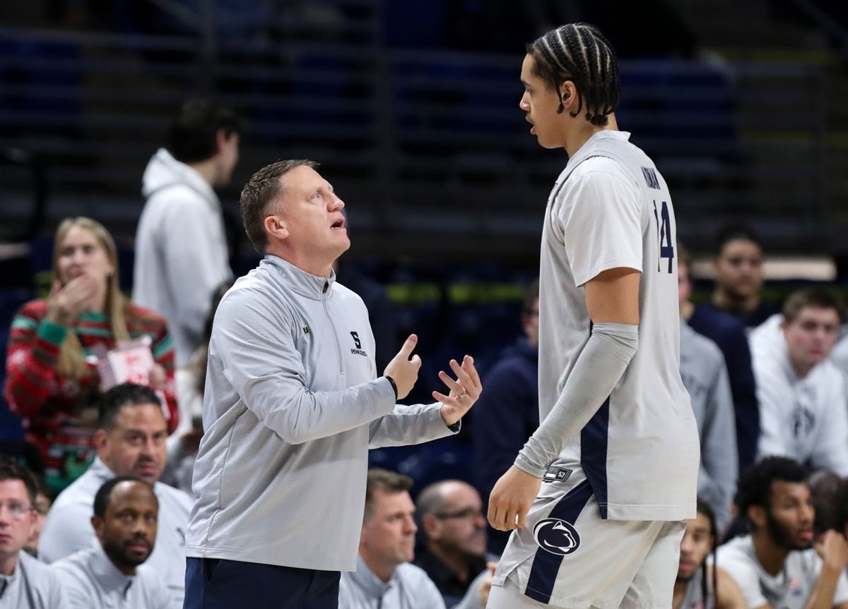 Dec 14, 2024; University Park, Pennsylvania, USA; Penn State Nittany Lions head coach Mike Rhoades talks with forward Yanic Konan Niederhauser (14) during the first half against the Coppin State Eagles at Bryce Jordan Center. Penn State won 99-51. Mandatory Credit: Matthew O'Haren-Imagn Images