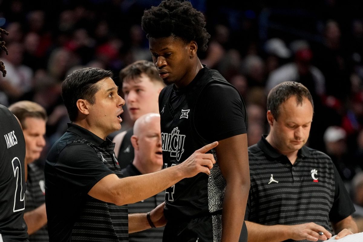 Cincinnati Bearcats head coach Wes Miller talks with forward Tyler McKinley (24) in the first half of the 92nd Annual Crosstown Shootout NCAA basketball game between the Cincinnati Bearcats and the Xavier Musketeers at Fifth Third Arena on the UC campus in Cincinnati on Saturday, Dec. 14, 2024. Xavier led 31-30 at halftime.