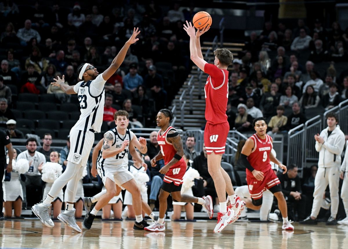 Dec 14, 2024; Indianapolis, Indiana, USA;  Wisconsin Badgers forward Nolan Winter (31) attempts a shot over Butler Bulldogs center Andre Screen (23) during the first half at Gainbridge Fieldhouse. Mandatory Credit: Robert Goddin-Imagn Images