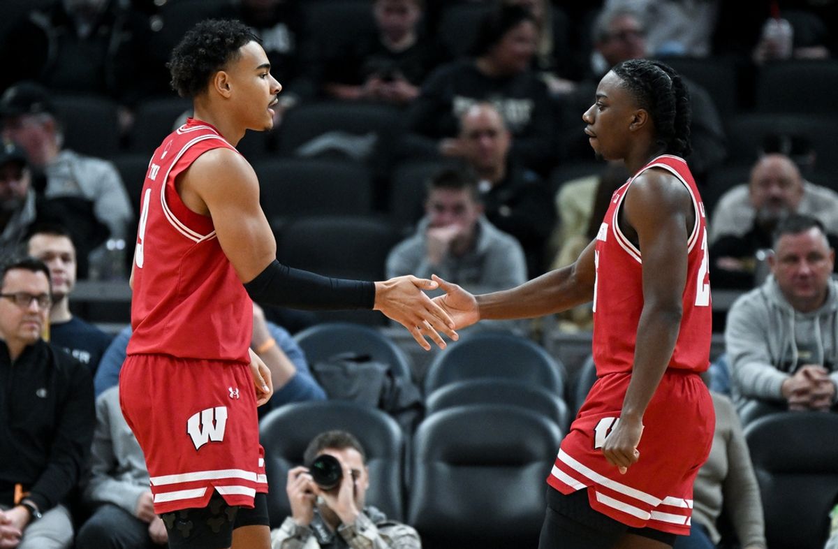 Dec 14, 2024; Indianapolis, Indiana, USA;  Wisconsin Badgers guard John Tonje (9) and guard John Blackwell (25) react after a play during the first half against the Butler Bulldogs at Gainbridge Fieldhouse. Mandatory Credit: Robert Goddin-Imagn Images