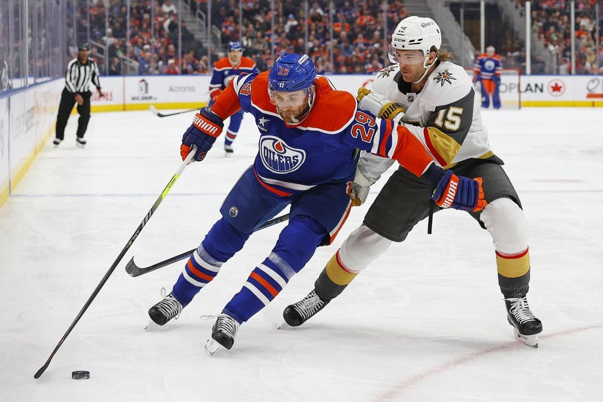 Dec 14, 2024; Edmonton, Alberta, CAN; Edmonton Oilers forward Leon Draisaitl (29) protects the puck from Vegas Golden Knights defensemen Noah Hanifin (15) during the first period at Rogers Place. Mandatory Credit: Perry Nelson-Imagn Images
