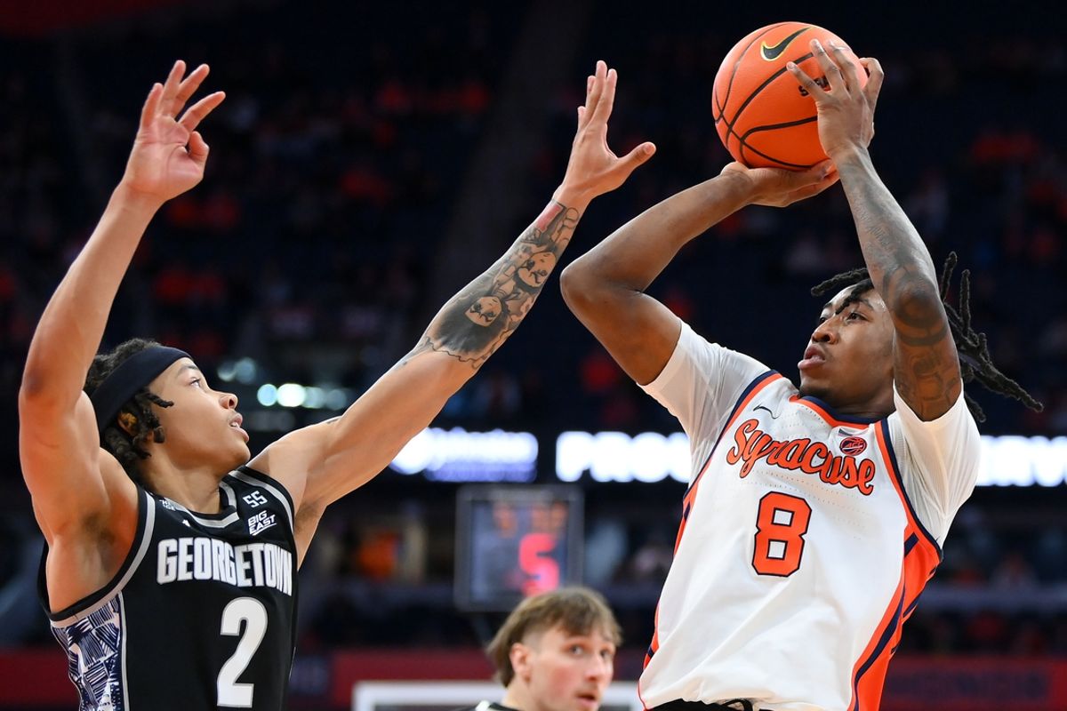 Dec 14, 2024; Syracuse, New York, USA; Syracuse Orange guard Elijah Moore (8) shoots the ball as Georgetown Hoyas guard Malik Mack (2) defends during the second half at the JMA Wireless Dome. Mandatory Credit: Rich Barnes-Imagn Images