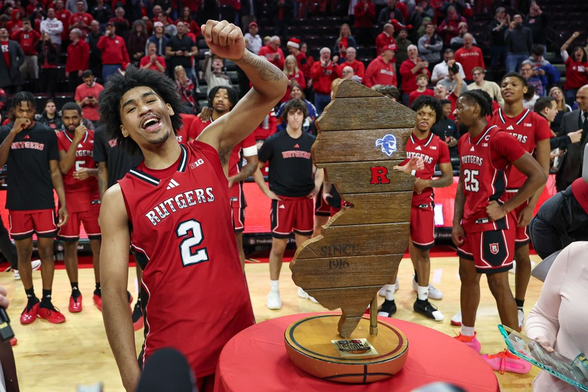 Dec 14, 2024; Piscataway, New Jersey, USA; Rutgers Scarlet Knights guard Dylan Harper (2) celebrates with the Garden State Hardwood Classic trophy after defeating the Seton Hall Pirates at Jersey Mike's Arena. Mandatory Credit: Vincent Carchietta-Imagn Images