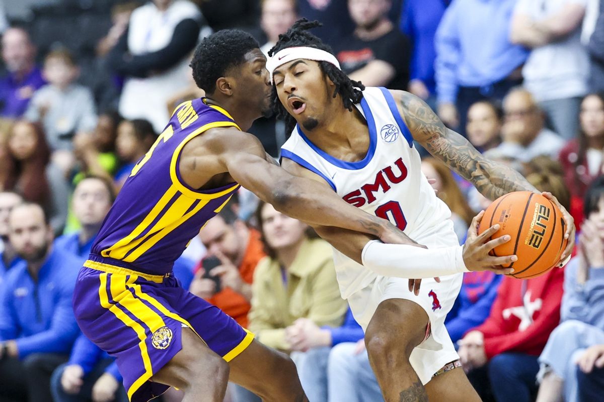 Dec 14, 2024; Frisco, Texas, USA;  LSU Tigers guard Cam Carter (5) fouls Southern Methodist Mustangs guard B.J. Edwards (0) during the second half at Comerica Center. Mandatory Credit: Kevin Jairaj-Imagn Images