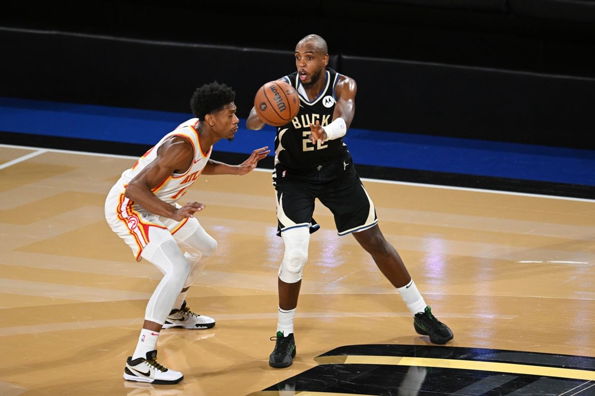 Dec 14, 2024; Las Vegas, Nevada, USA; Milwaukee Bucks forward Khris Middleton (22) passes against Atlanta Hawks forward De'Andre Hunter (12) during the fourth quarter in a semifinal of the 2024 Emirates NBA Cup at T-Mobile Arena. Mandatory Credit: Candice Ward-Imagn Images