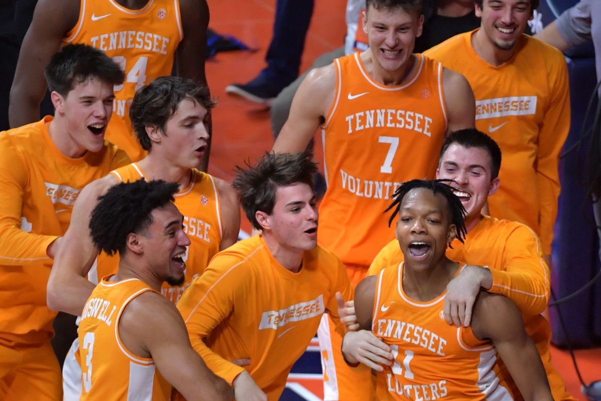 Dec 14, 2024; Champaign, Illinois, USA;  Tennessee Volunteers guard Jordan Gainey (11) is mobbed by teammates after scoring with seconds left before winning the game against the Illinois Fighting Illini at State Farm Center. Mandatory Credit: Ron Johnson-Imagn Images
