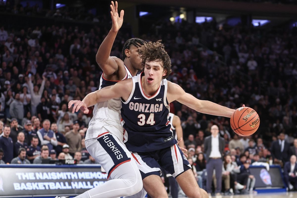 Dec 14, 2024; New York, New York, USA;  Gonzaga Bulldogs forward Braden Huff (34) spins away from Connecticut Huskies center Tarris Reed Jr. (5) in the second half at Madison Square Garden. Mandatory Credit: Wendell Cruz-Imagn Images