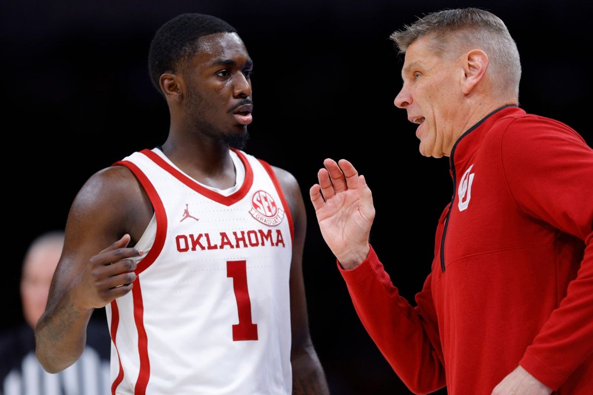 Oklahoma coach Porter Moser talks with Oklahoma Sooners guard Kobe Elvis (1) during a men's college Bedlam basketball game between the University of Oklahoma Sooners (OU) and the Oklahoma State University Cowboys (OSU) at Paycom Center in Oklahoma City, Saturday, Dec. 14, 2024. Oklahoma won 80-65.