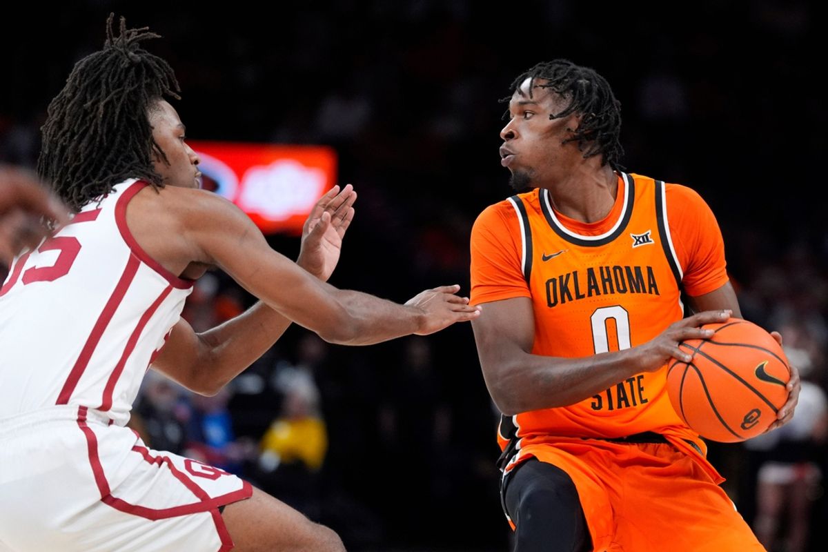Oklahoma State Cowboys forward Marchelus Avery (0) looks to pass as Oklahoma Sooners forward Glenn Taylor Jr. (35) defends during a men's college Bedlam basketball game between the University of Oklahoma Sooners (OU) and the Oklahoma State University Cowboys (OSU) at Paycom Center in Oklahoma City, Saturday, Dec. 14, 2024. Oklahoma won 80-65.