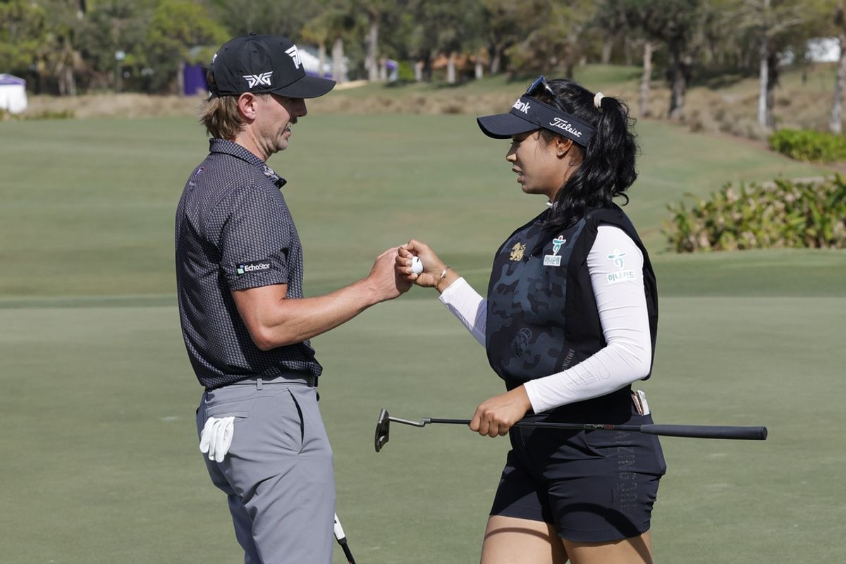 Dec 15, 2024; Naples, Florida, [USA];  Jake Knapp (left) fist bumps teammate Patty Tavatanakit during final round play of the Grant Thornton Invitational at Tiburón Golf Club. Mandatory Credit: Reinhold Matay-Imagn Images