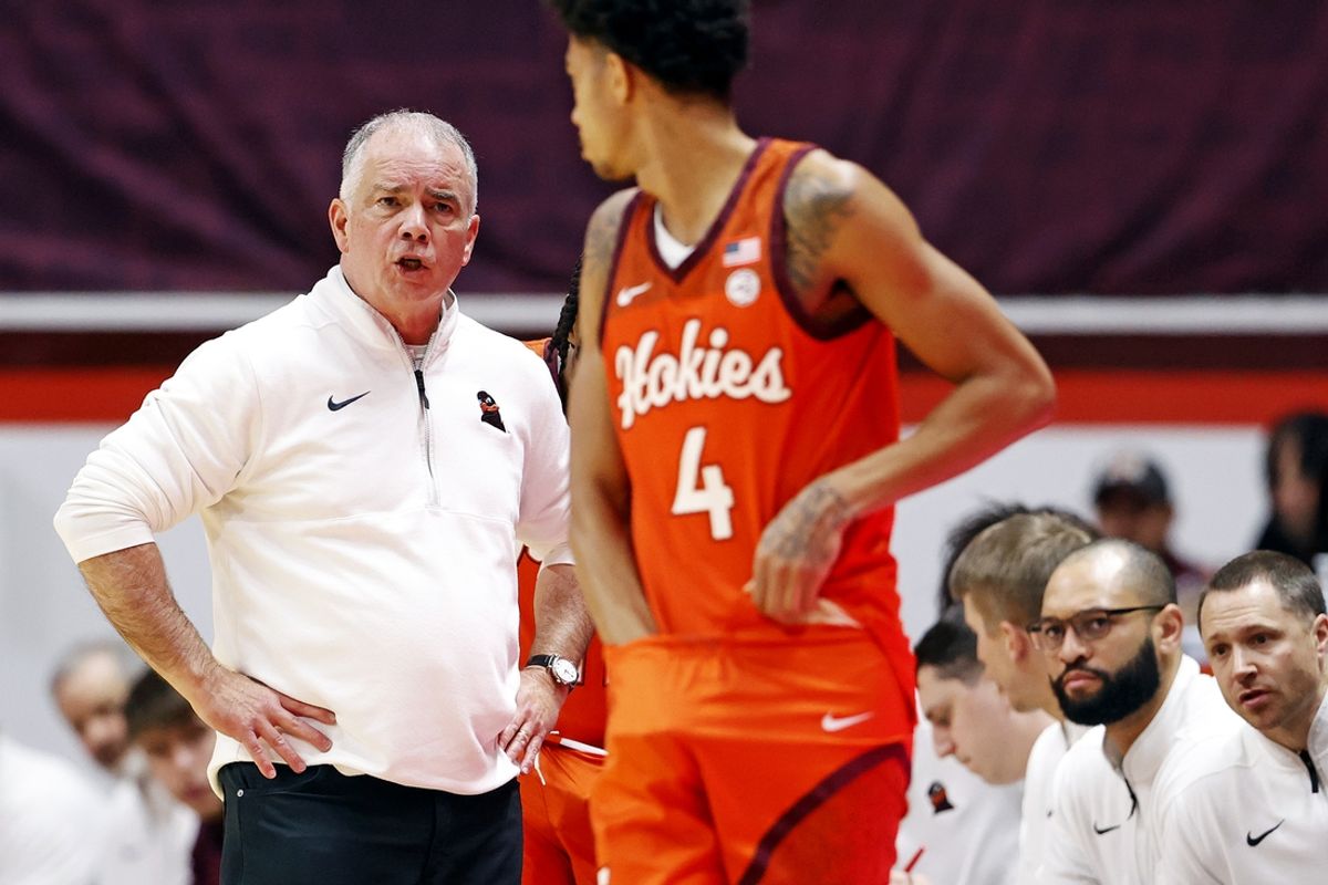 Dec 15, 2024; Blacksburg, Virginia, USA; Virginia Tech Hokies head coach Mike Young talks to guard Rodney Brown Jr. (4) during the first half against the Navy Midshipmen at Cassell Coliseum. Mandatory Credit: Peter Casey-Imagn Images