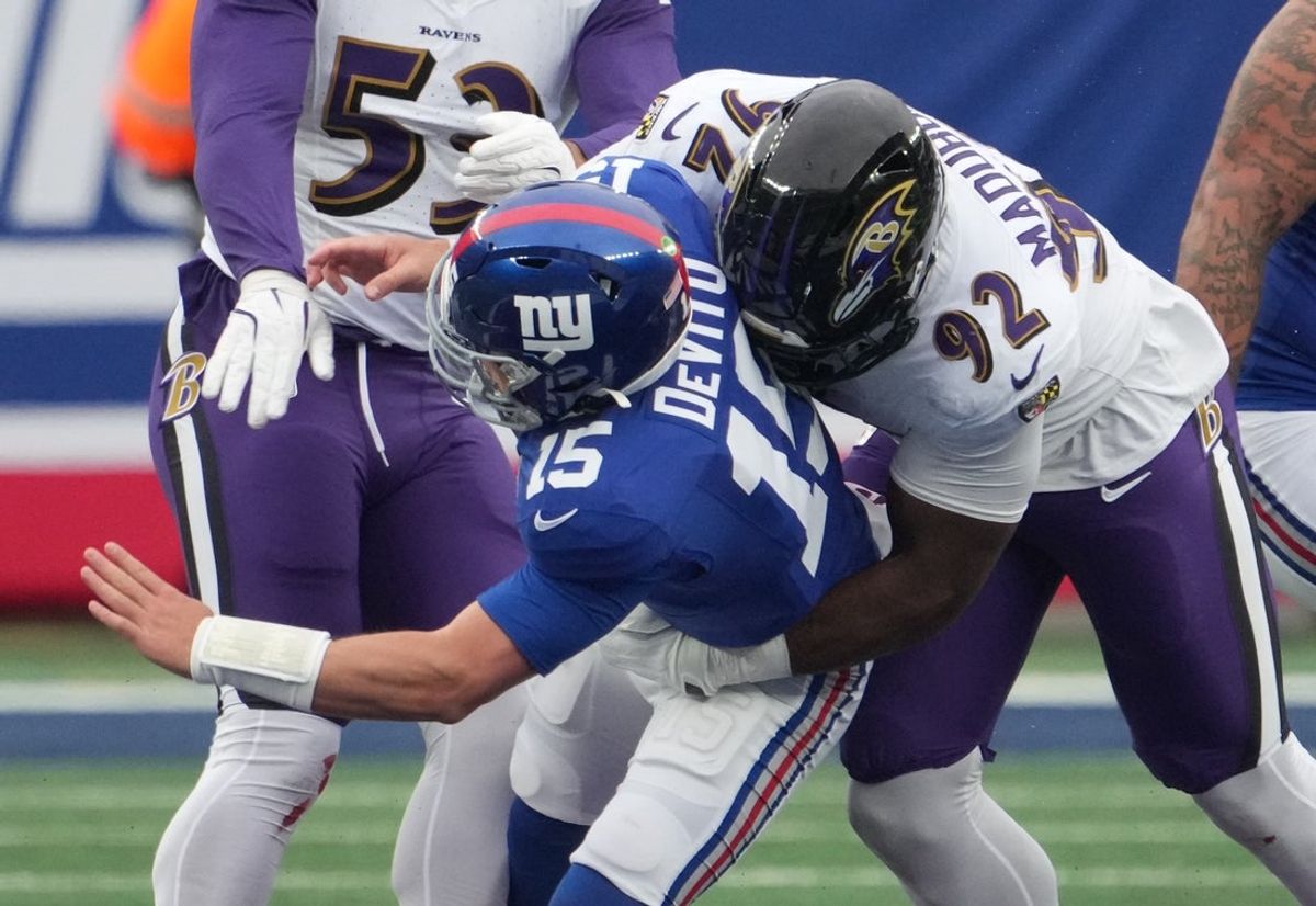 Dec 15, 2024; East Rutherford, New Jersey, USA; Baltimore Ravens defensive tackle Nnamdi Madubuike (92) is flagged for roughing the passer on New York Giants quarterback Tommy DeVito (15) during the first half at MetLife Stadium. Mandatory Credit: Robert Deutsch-Imagn Images