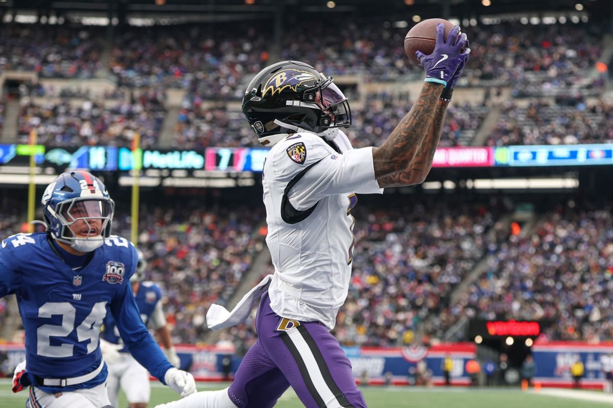 Dec 15, 2024; East Rutherford, New Jersey, USA; Baltimore Ravens wide receiver Rashod Bateman (7) catches a touchdown pass in front of New York Giants safety Dane Belton (24) during the first half at MetLife Stadium. Mandatory Credit: Vincent Carchietta-Imagn Images