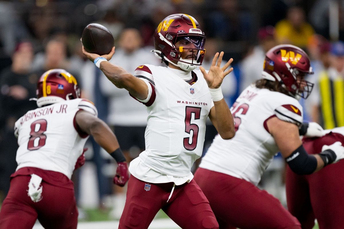 Dec 15, 2024; New Orleans, Louisiana, USA; Washington Commanders quarterback Jayden Daniels (5) throws against the New Orleans Saints during the first half at Caesars Superdome. Mandatory Credit: Matthew Hinton-Imagn Images