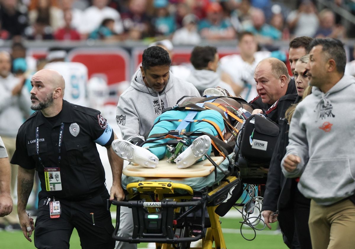 Dec 15, 2024; Houston, Texas, USA;  Miami Dolphins wide receiver Grant DuBose (88) is taken off the filed by the medical team after he was injured during the third quarter against the Houston Texans at NRG Stadium. Mandatory Credit: Thomas Shea-Imagn Images