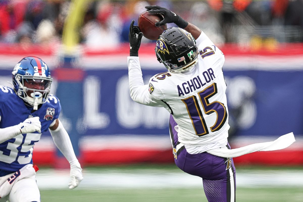 Dec 15, 2024; East Rutherford, New Jersey, USA; Baltimore Ravens wide receiver Nelson Agholor (15) catches the ball in front of New York Giants cornerback Art Green (35) during the second half at MetLife Stadium. Mandatory Credit: Vincent Carchietta-Imagn Images
