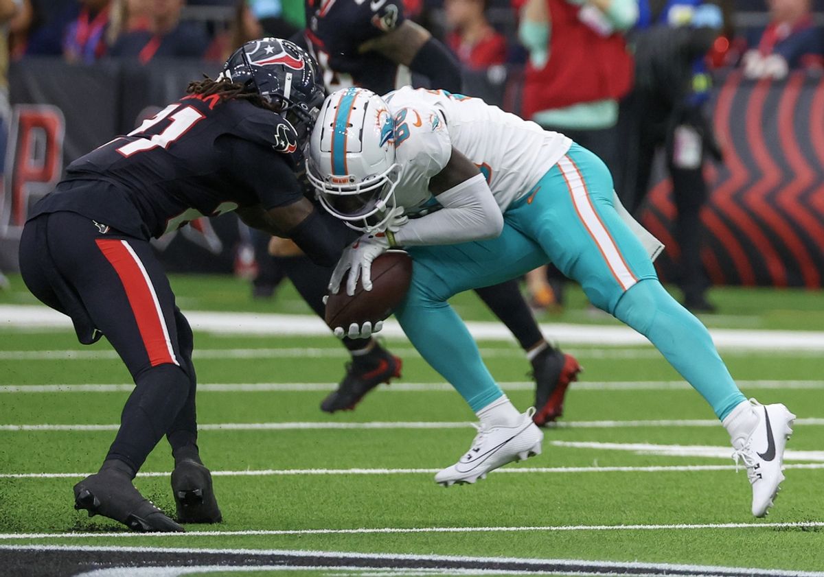 Dec 15, 2024; Houston, Texas, USA; Miami Dolphins wide receiver Grant DuBose (88) is tackled by Houston Texans safety Calen Bullock (21) in the third quarter at NRG Stadium. Miami Dolphins wide receiver Grant DuBose (88) was injured on the play and had to leave the game. Mandatory Credit: Thomas Shea-Imagn Images