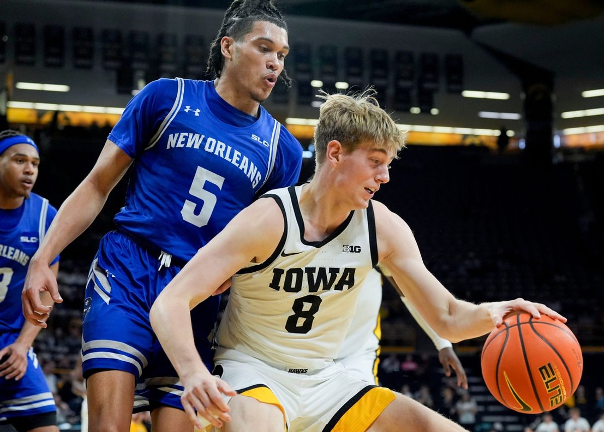 Iowa Hawkeyes forward Cooper Koch (8) drives into the lane against New Orleans Privateers guard James White (5) Sunday, Dec. 15, 2024 at Carver-Hawkeye Arena in Iowa City, Iowa.