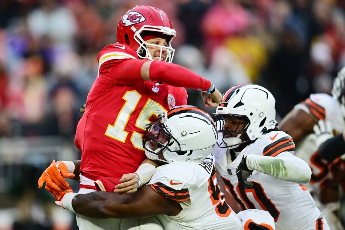 Dec 15, 2024; Cleveland, Ohio, USA; Cleveland Browns defensive tackle Mike Hall Jr. (51) and linebacker Devin Bush (30) rush Kansas City Chiefs quarterback Patrick Mahomes (15) during the second half at Huntington Bank Field. Mandatory Credit: Ken Blaze-Imagn Images