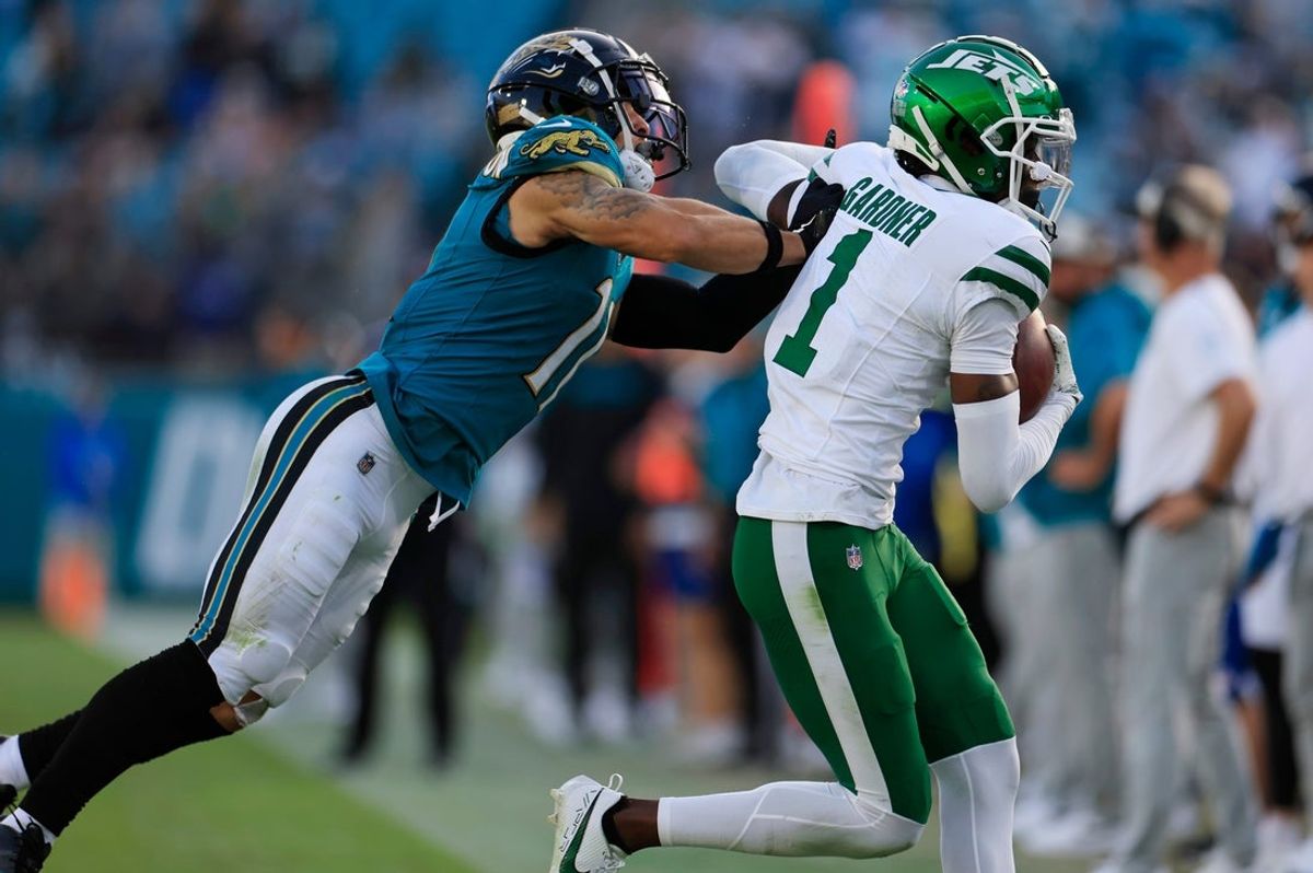 New York Jets cornerback Sauce Gardner (1) hauls in an interception against Jacksonville Jaguars wide receiver Parker Washington (11) during the fourth quarter Sunday, Dec. 15, 2024 at EverBank Stadium in Jacksonville, Fla. The Jets held off the Jaguars 32-25. [Corey Perrine/Florida Times-Union]