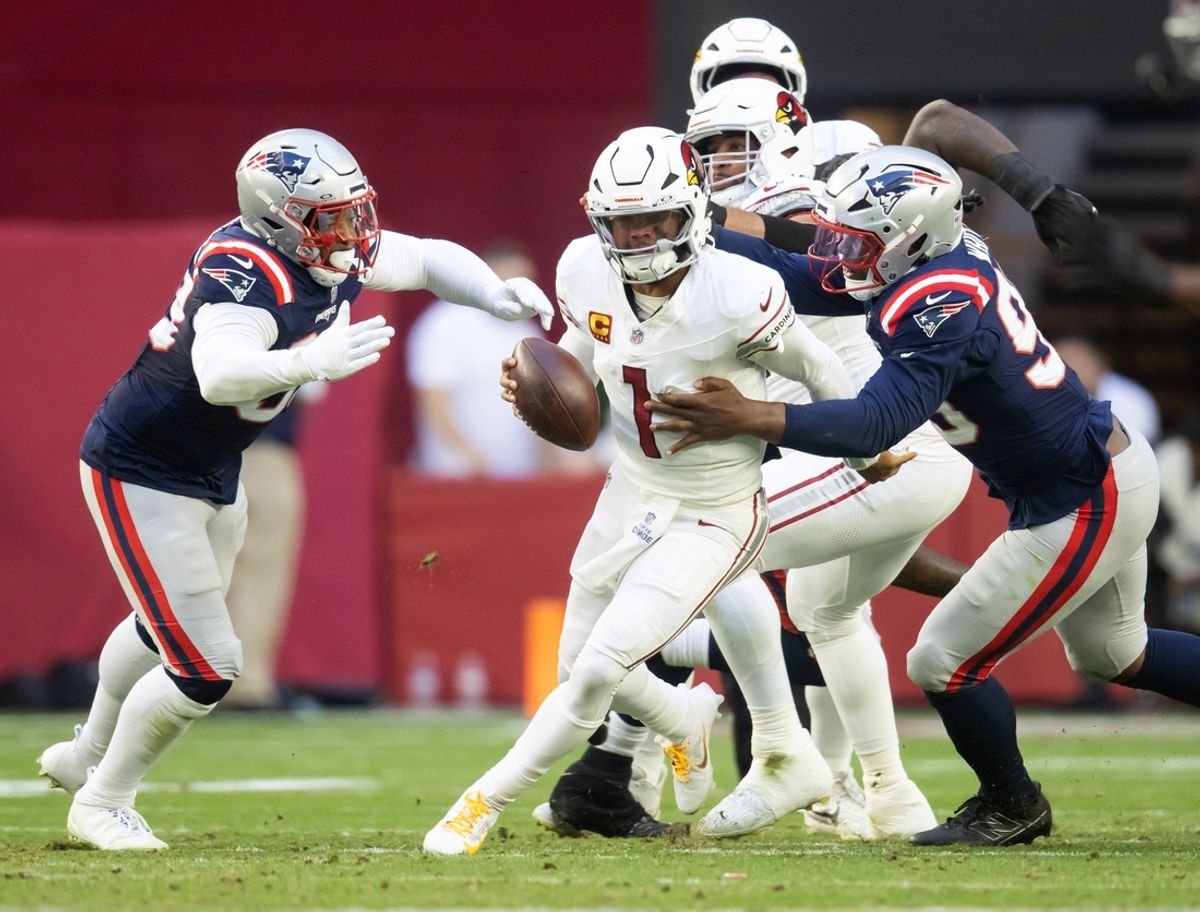 Dec 15, 2024; Glendale, Arizona, USA; Arizona Cardinals quarterback Kyler Murray (1) is sacked by New England Patriots defensive end Keion White (99) and linebacker Anfernee Jennings (33) in the first half at State Farm Stadium. Mandatory Credit: Mark J. Rebilas-Imagn Images