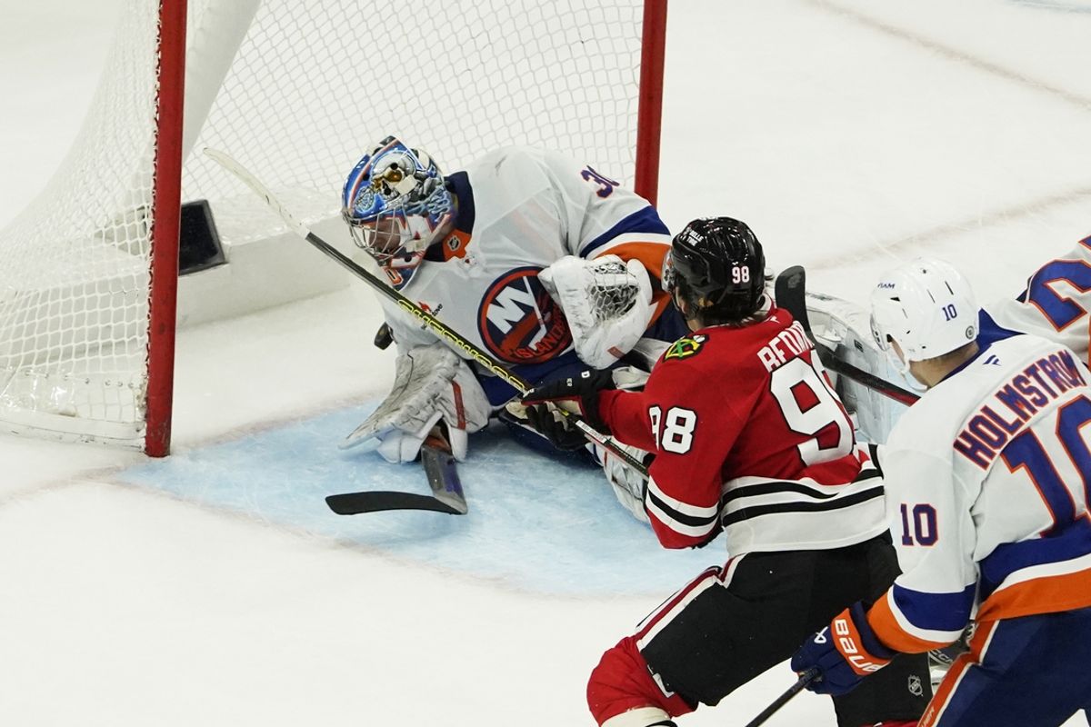 Dec 15, 2024; Chicago, Illinois, USA; Chicago Blackhawks center Connor Bedard (98) scores the winning goal on New York Islanders goaltender Ilya Sorokin (30) during the third period at United Center. Mandatory Credit: David Banks-Imagn Images