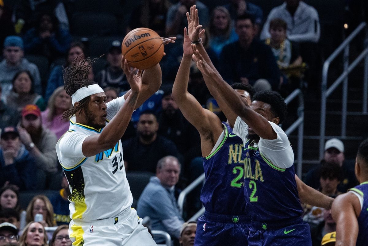 Dec 15, 2024; Indianapolis, Indiana, USA; Indiana Pacers center Myles Turner (33) passes the ball while New Orleans Pelicans forward Herbert Jones (2) defends in the first half at Gainbridge Fieldhouse. Mandatory Credit: Trevor Ruszkowski-Imagn Images