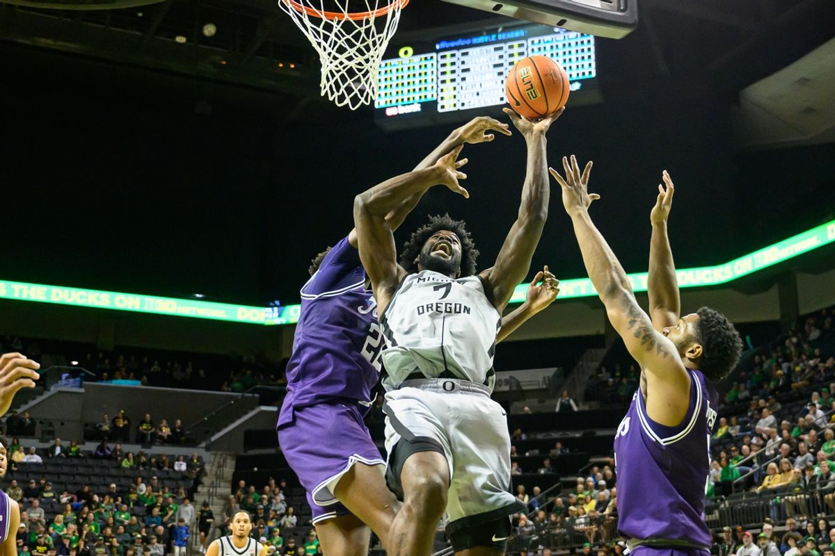 Dec 15, 2024; Eugene, Oregon, USA; Oregon Ducks forward Supreme Cook (7) drives to the basket against Stephen F. Austin Lumberjacks forward Nana Antwi-Boasiako (22) during the first half at Matthew Knight Arena. Mandatory Credit: Craig Strobeck-Imagn Images