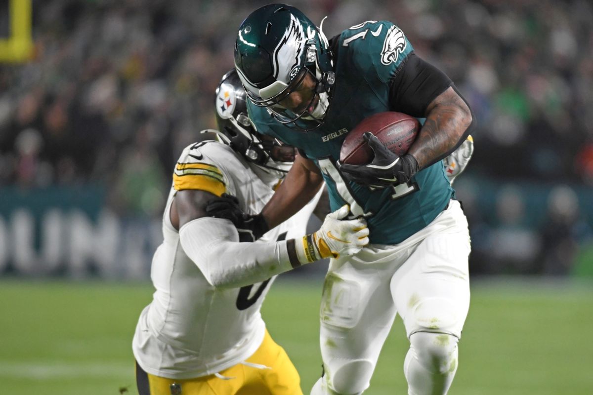 Dec 15, 2024; Philadelphia, Pennsylvania, USA; Philadelphia Eagles running back Kenneth Gainwell (14) is tackled by Pittsburgh Steelers linebacker Patrick Queen (6) during the third quarter at Lincoln Financial Field. Mandatory Credit: Eric Hartline-Imagn Images