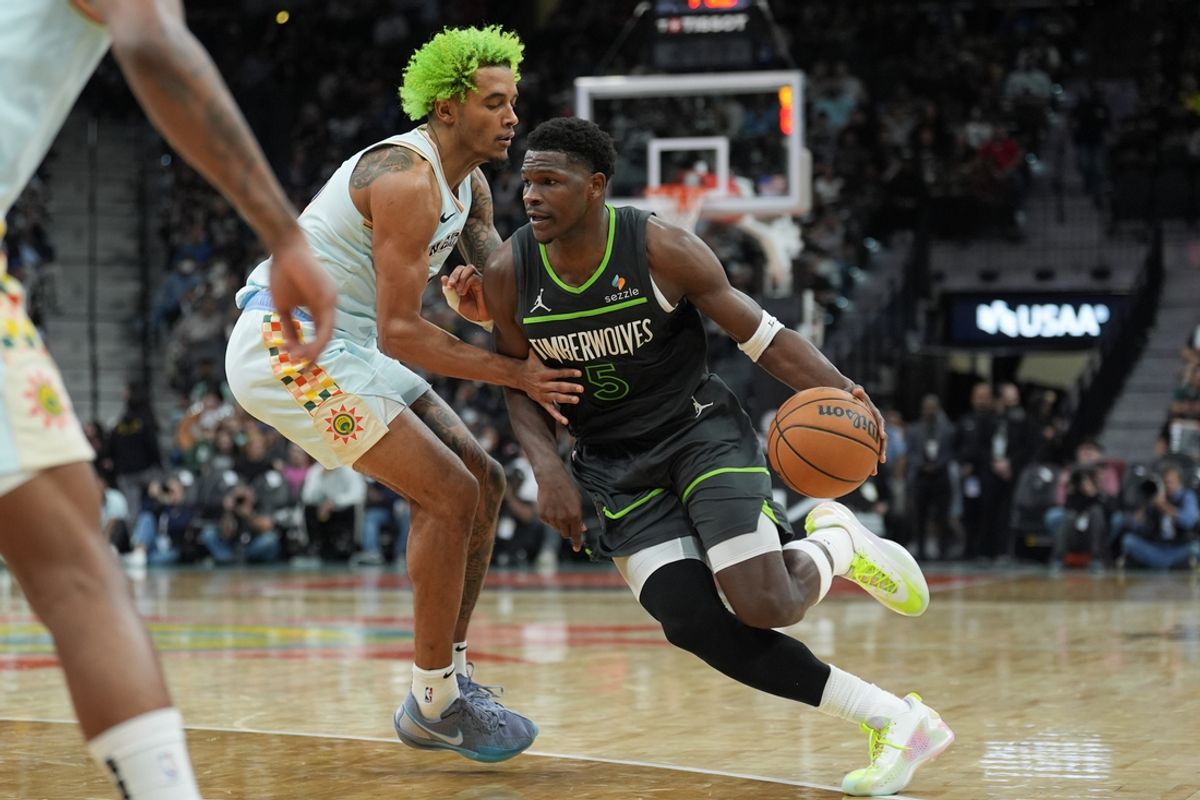 Dec 15, 2024; San Antonio, Texas, USA;  Minnesota Timberwolves guard Anthony Edwards (5) dribbles against San Antonio Spurs forward Jeremy Sochan (10) in the first half at Frost Bank Center. Mandatory Credit: Daniel Dunn-Imagn Images