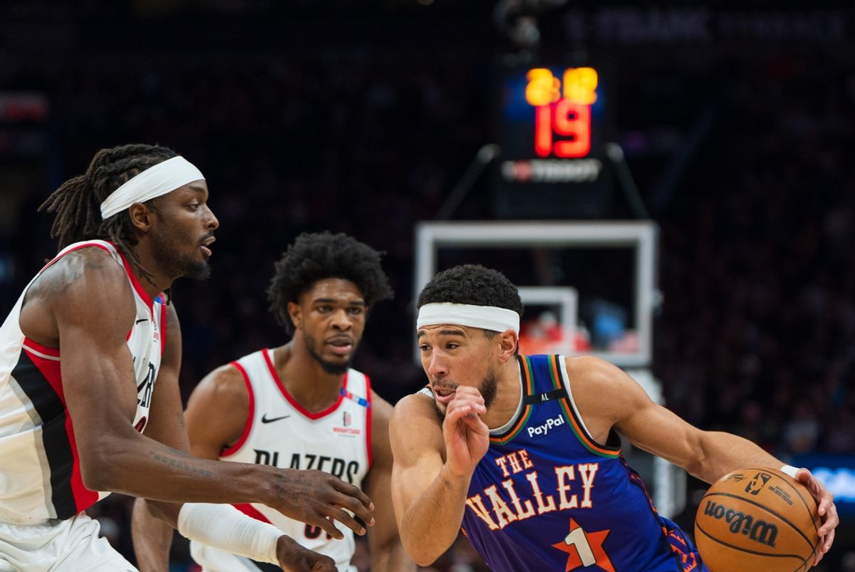 Dec 15, 2024; Phoenix, Arizona, USA; Phoenix Suns guard Devin Booker (1) drives on Portland Trail Blazers forward Jerami Grant (9) in the first half of a game at Footprint Center. Mandatory Credit: Allan Henry-Imagn Images