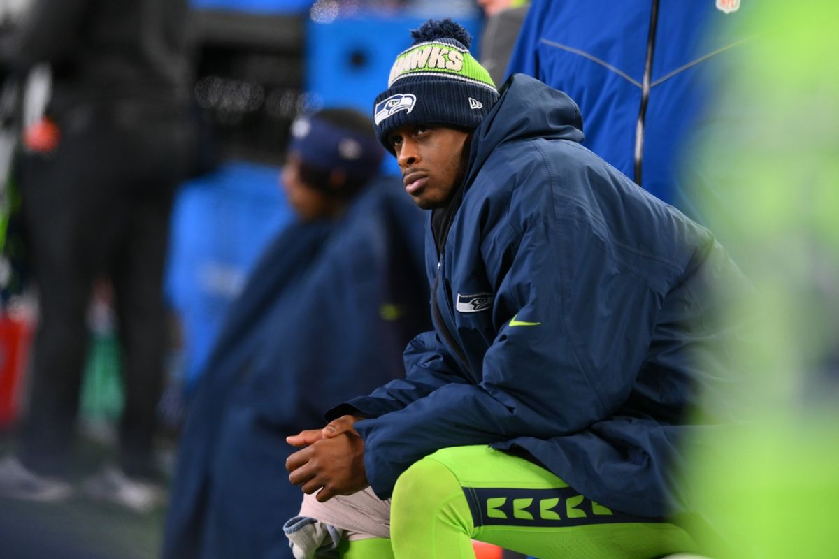 Dec 15, 2024; Seattle, Washington, USA; Seattle Seahawks quarterback Geno Smith (7) sits on the bench after an injury during the second half against the Green Bay Packers at Lumen Field. Mandatory Credit: Steven Bisig-Imagn Images