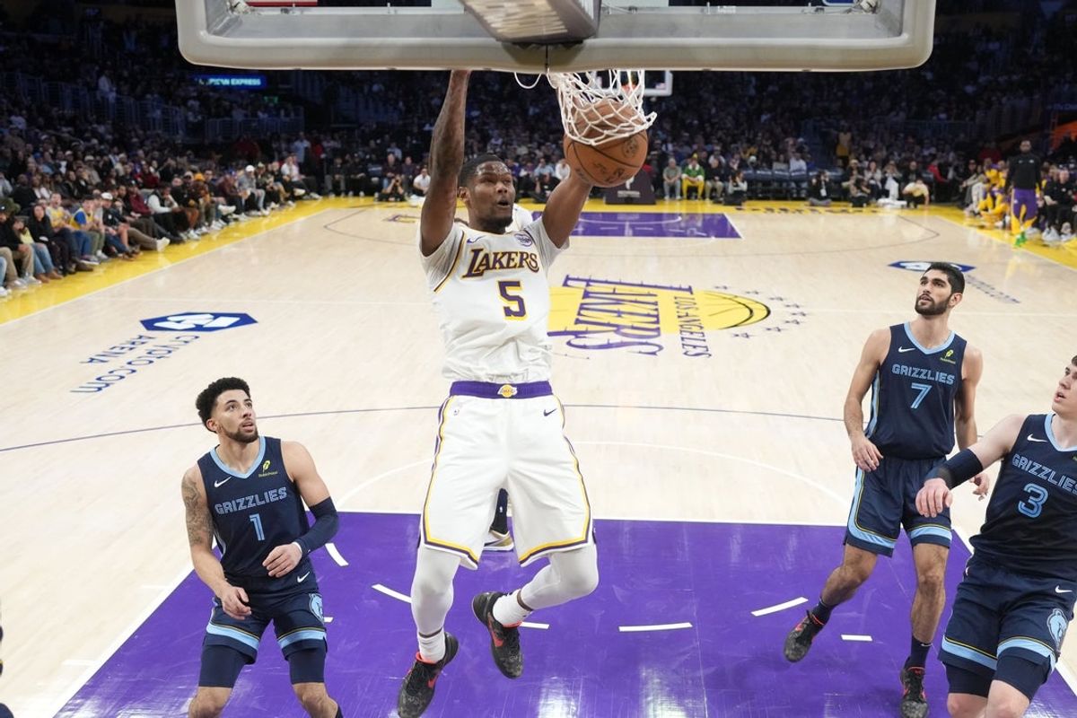 Dec 15, 2024; Los Angeles, California, USA; Los Angeles Lakers forward Cam Reddish (5) dunks the ball in the first half against the Memphis Grizzlies at Crypto.com Arena. Mandatory Credit: Kirby Lee-Imagn Images