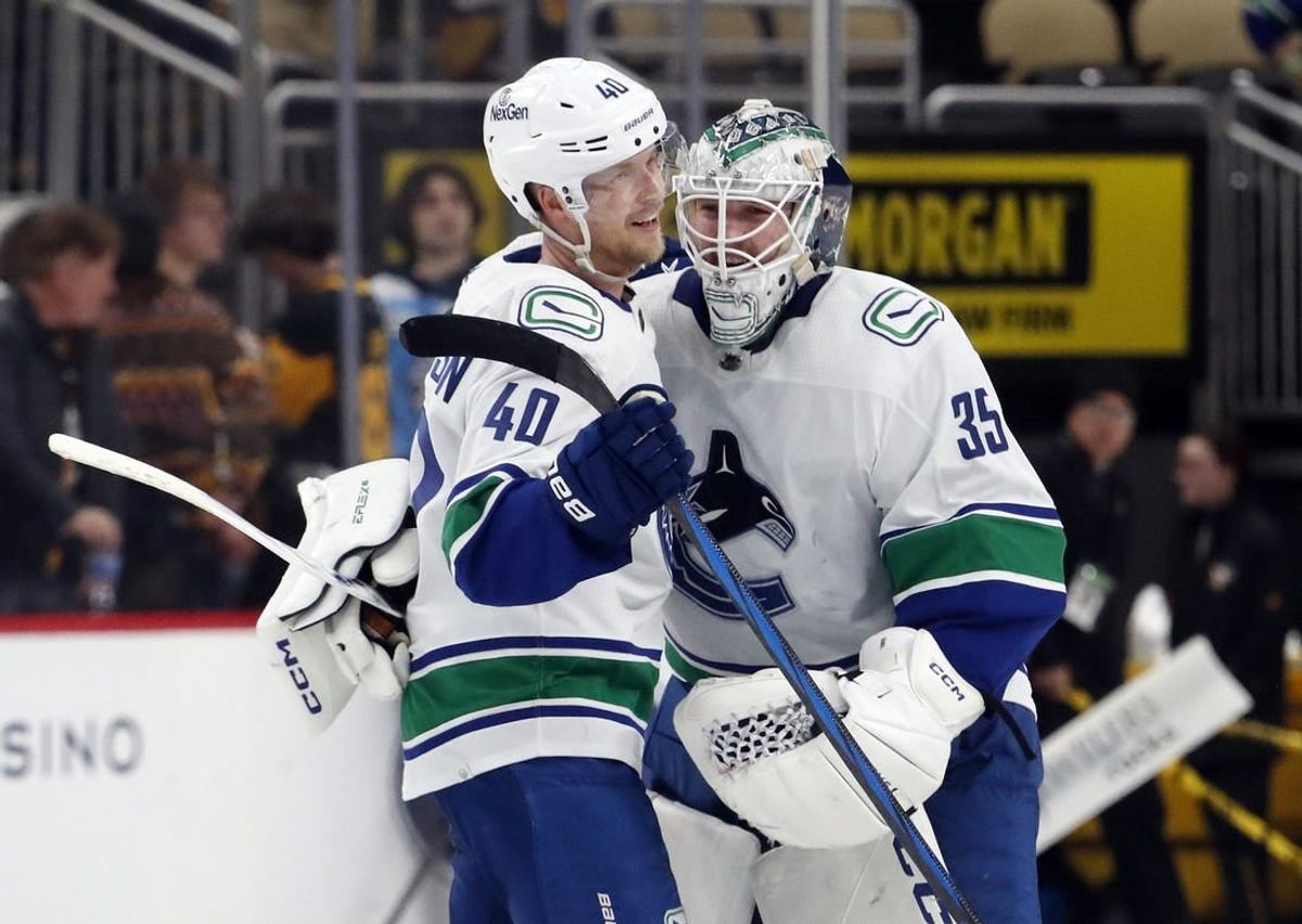 Jan 11, 2024; Pittsburgh, Pennsylvania, USA; Vancouver Canucks center Elias Pettersson (40) and goaltender Thatcher Demko (35) celebrate after defeating the Pittsburgh Penguins in overtime at PPG Paints Arena. The Canucks won 4-3 in overtime.