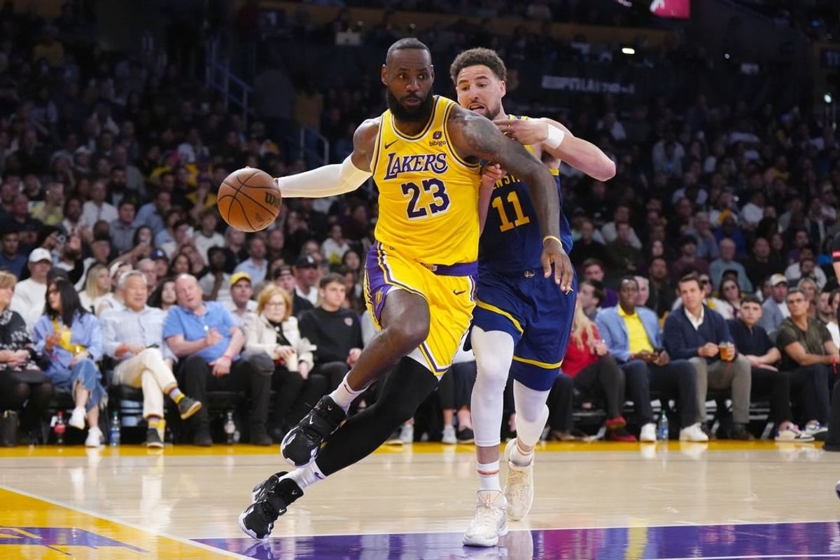 Apr 9, 2024; Los Angeles, California, USA; Los Angeles Lakers forward LeBron James (23) drives to the basket against Golden State Warriors guard Klay Thompson (11) in the first half at Crypto.com Arena.