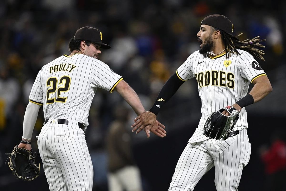 Apr 8, 2024; San Diego, California, USA; San Diego Padres third baseman Graham Pauley (22) and right fielder Fernando Tatis Jr. (23) celebrate after defeating the Chicago Cubs at Petco Park.
