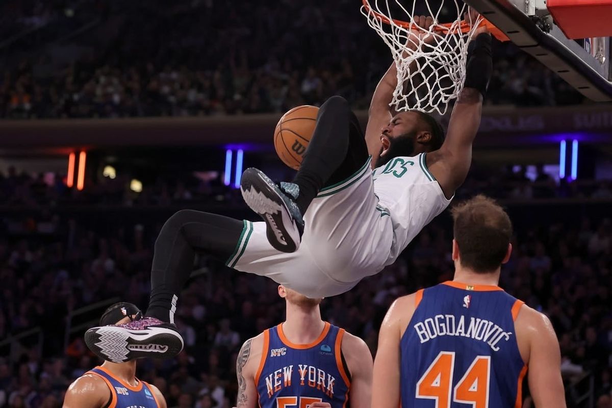 Feb 24, 2024; New York, New York, USA; Boston Celtics guard Jaylen Brown (7) hangs on the rim after a dunk against New York Knicks guard Josh Hart (3) and center Isaiah Hartenstein (55) and forward Bojan Bogdanovic (44) during the second quarter at Madison Square Garden.