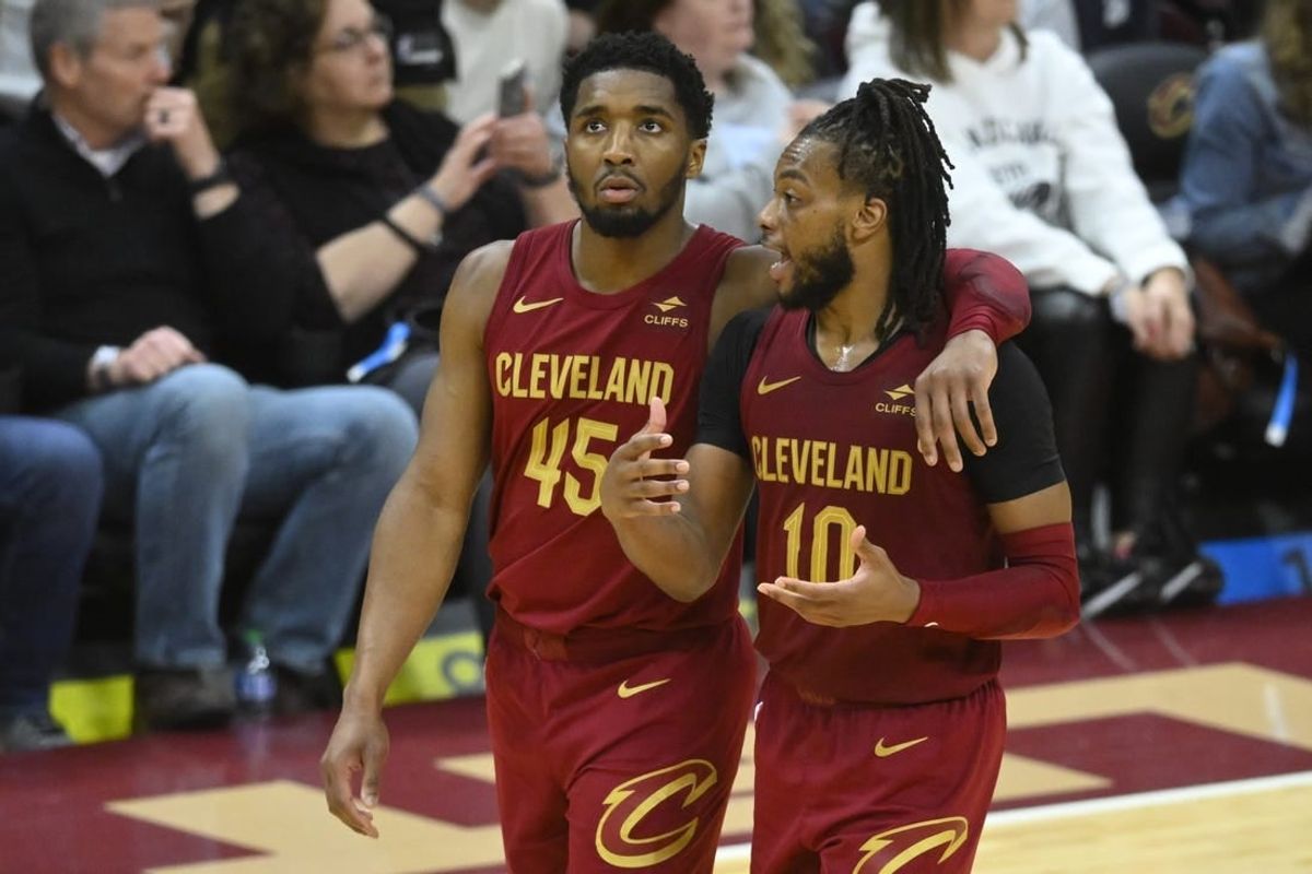 Apr 12, 2024; Cleveland, Ohio, USA; Cleveland Cavaliers guard Donovan Mitchell (45) and guard Darius Garland (10) talk in the fourth quarter against the Indiana Pacers at Rocket Mortgage FieldHouse.