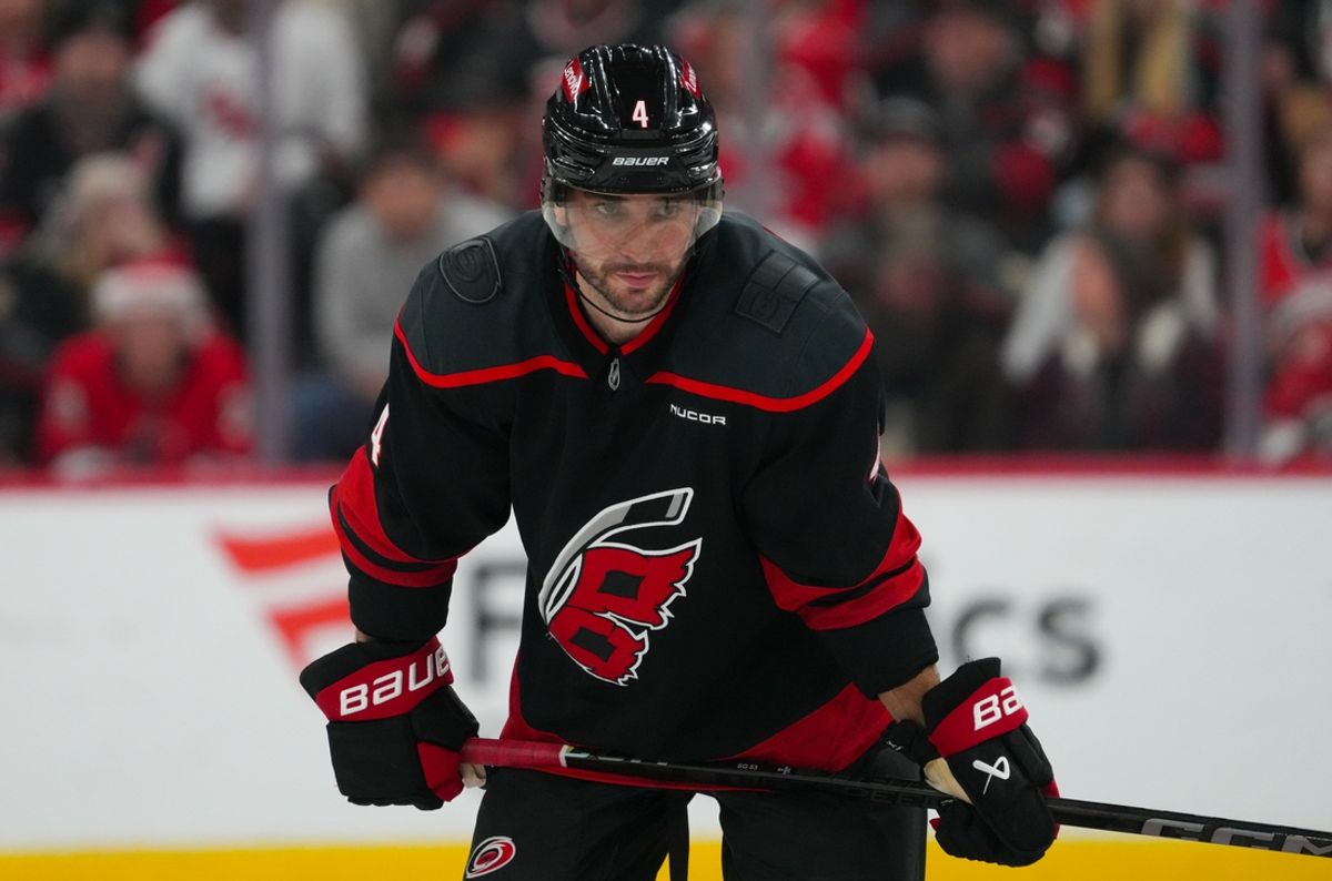Dec 10, 2024; Raleigh, North Carolina, USA;  Carolina Hurricanes defenseman Shayne Gostisbehere (4) looks on against the San Jose Sharks during the third period at Lenovo Center. Mandatory Credit: James Guillory-Imagn Images