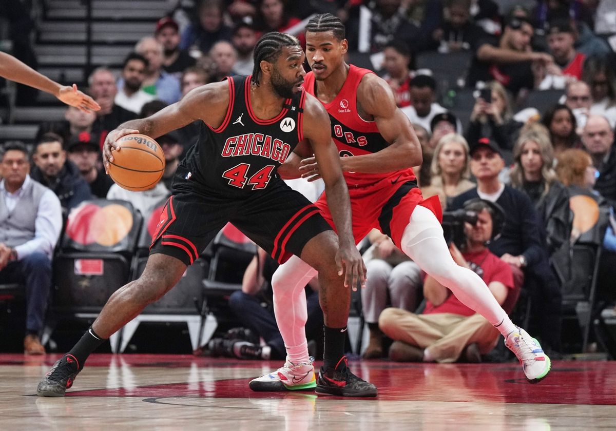 Dec 16, 2024; Toronto, Ontario, CAN; Chicago Bulls forward Patrick Williams (44) controls the ball against Toronto Raptors guard Ochai Agbaji (30) during the first quarter at Scotiabank Arena. Mandatory Credit: Nick Turchiaro-Imagn Images