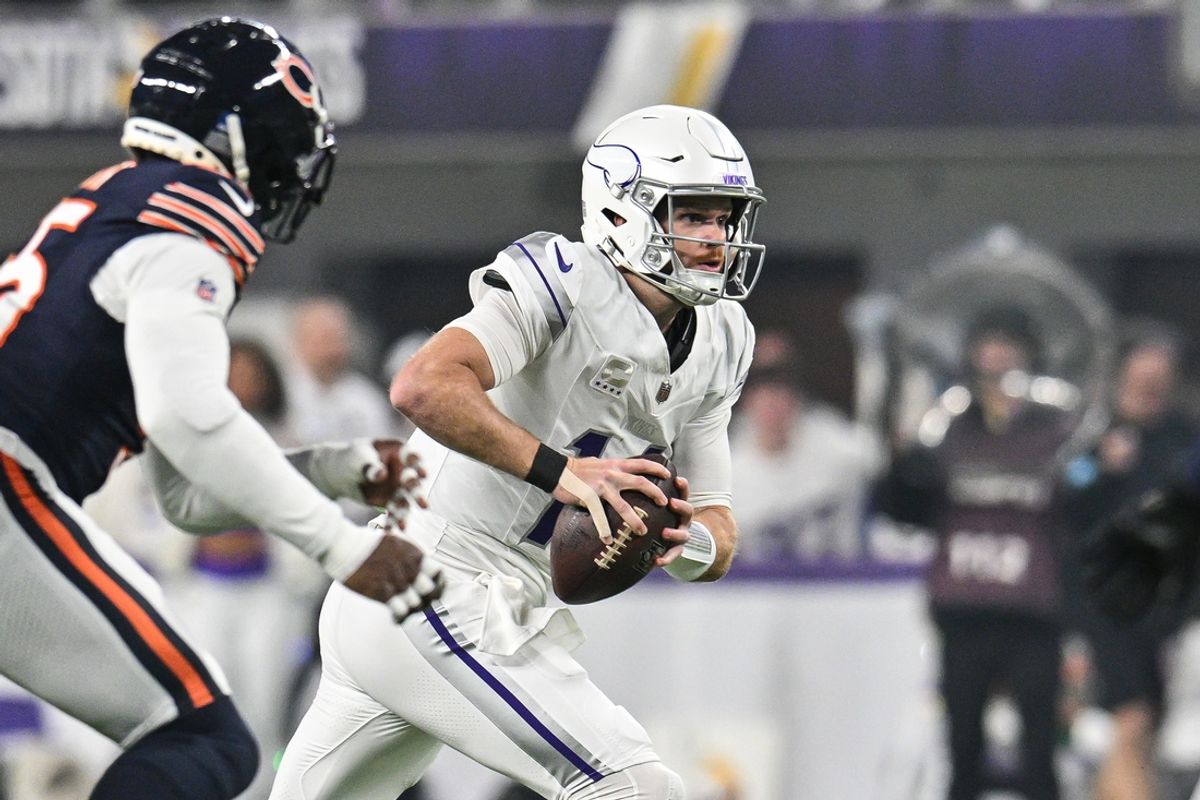 Dec 16, 2024; Minneapolis, Minnesota, USA; Minnesota Vikings quarterback Sam Darnold (14) runs the ball against the Chicago Bears during the first quarter at U.S. Bank Stadium. Mandatory Credit: Jeffrey Becker-Imagn Images