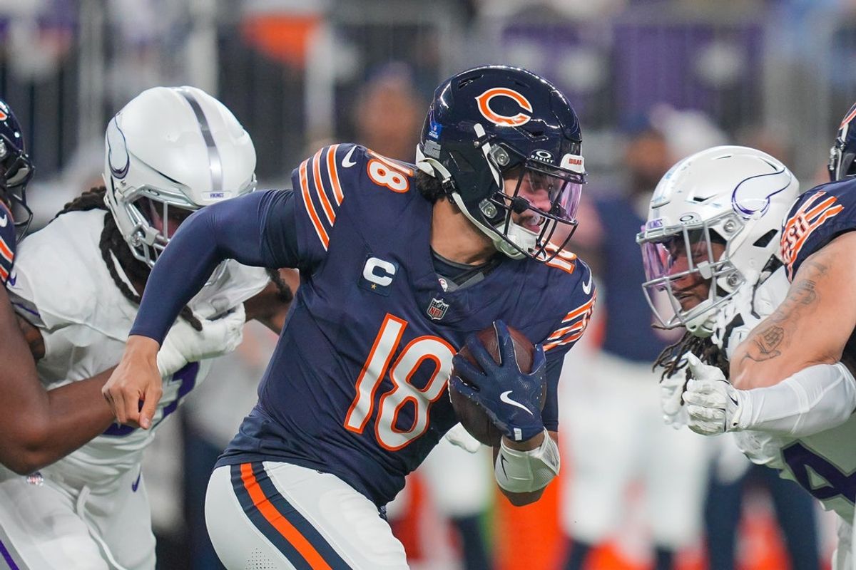 Dec 16, 2024; Minneapolis, Minnesota, USA; Chicago Bears quarterback Caleb Williams (18) runs with the ball against the Minnesota Vikings in the first quarter at U.S. Bank Stadium. Mandatory Credit: Brad Rempel-Imagn Images